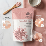 A stand-up pouch of Wild Organic French Pink Clay face mask powder is shown on a marble surface with a wooden spoon of the pink powder and decorative callout graphics explaining skin benefits.