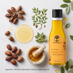 A bottle of Wild Organic Jojoba Oil is displayed in a styled flat-lay arrangement with raw ingredients including whole jojoba seeds, a bowl of melted yellow oil, and a marble mortar and pestle on a light gray background.