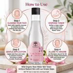 Wild Organic Rose Water Skin Toner bottle shown in a 'How to Use' infographic with four illustrated steps for cleansing, dispensing toner, gentle application, and absorbing the liquid. The bottle is clear glass with a black cap and a pink label, set on a marble surface with rose petals and soft floral background elements.