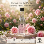 A clear bottle of Wild Organic Rose Water Skin Toner with a black cap and pink label, displayed on a stone slab surrounded by pink roses and petals, with the text 'Experience the Purity: Nature's Finest Rose Water' at the top.