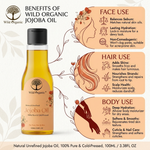 A bottle of Wild Organic Jojoba Oil displayed alongside informational panels detailing its benefits for face, hair, and body use. The bottle is a clear glass container with a black cap and a white label featuring the Wild Organic logo and illustrations of botanical elements.